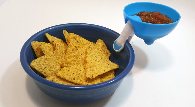 Salsa attached to a bowl of chips.